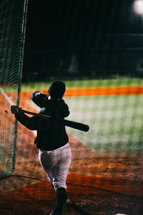 Back View of a Person Swinging a Bat