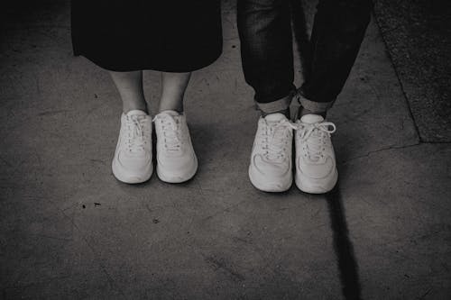 Free Two Persons Standing Side By Side Wearing Sneakers Stock Photo