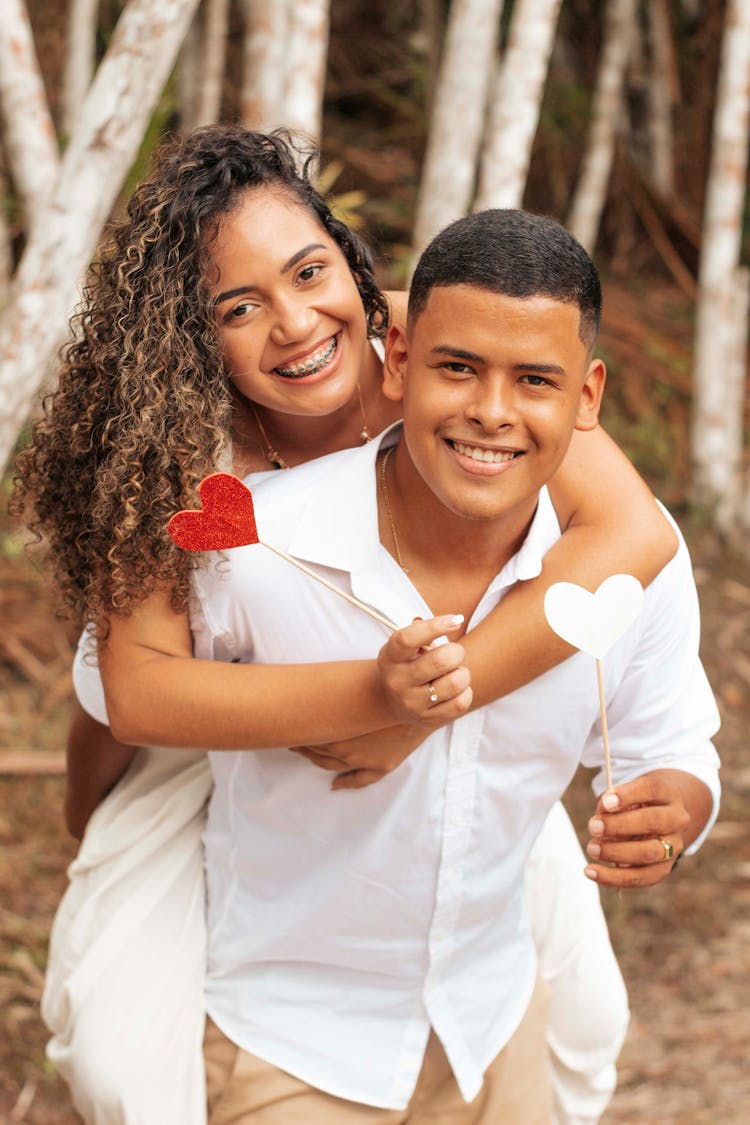 Young Man Carrying His Girlfriend On Back