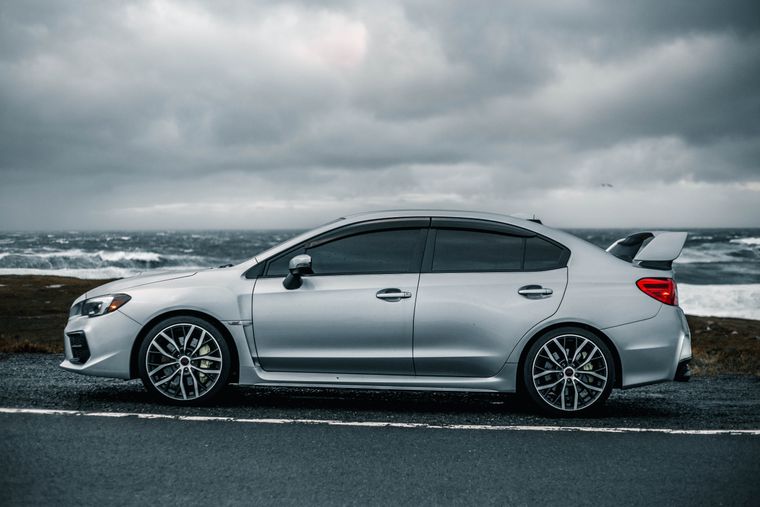 Metallic silver sedan in side profile — photo by Erik Mclean on Pexels