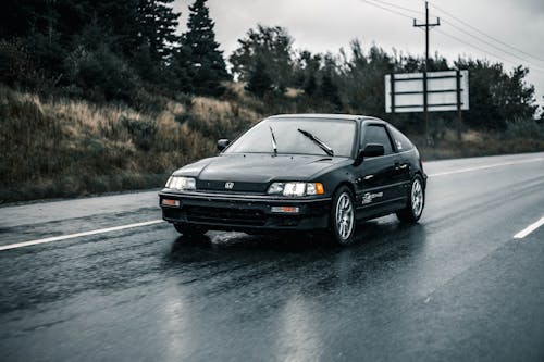 Free A Black Vintage Honda Car on the Road Stock Photo