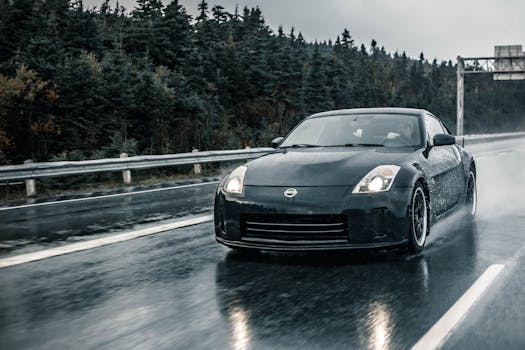 Nissan sports car speeding on wet road through a forested highway after rain.