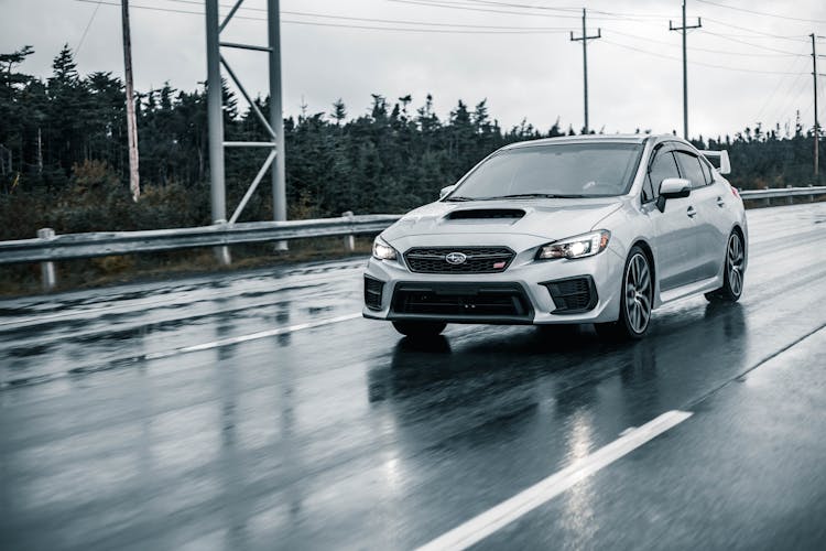 Silver Sedan On Wet Road