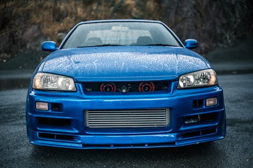 Wet Blue Car on Road