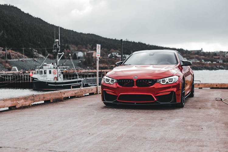 A Red Car Parked Near Dock