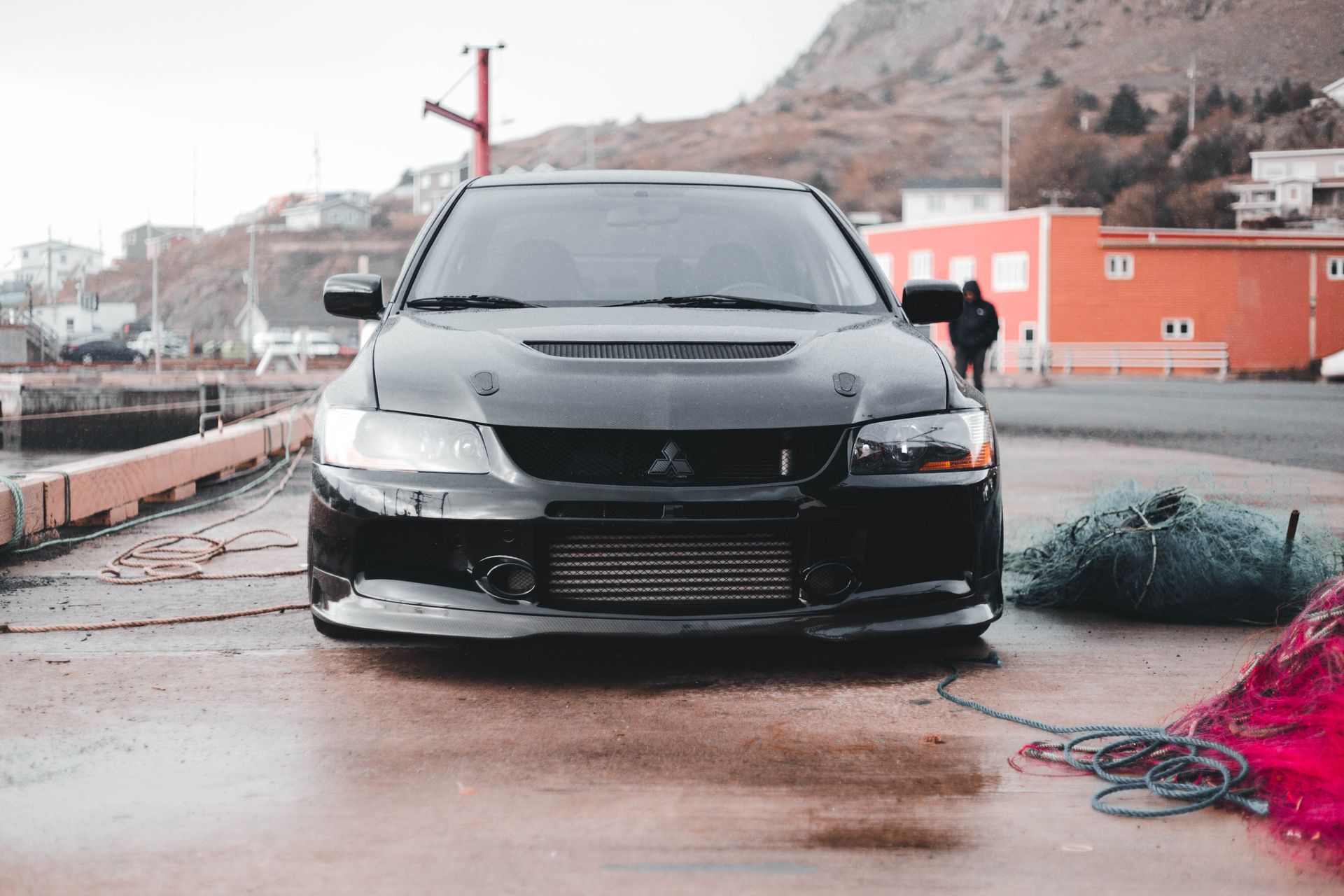 Close-up of a black Mitsubishi Lancer Evolution parked near a waterfront.