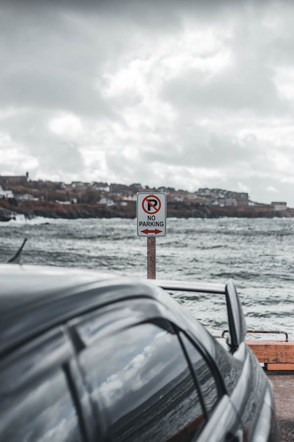 Red and White No Smoking Sign on Black Car