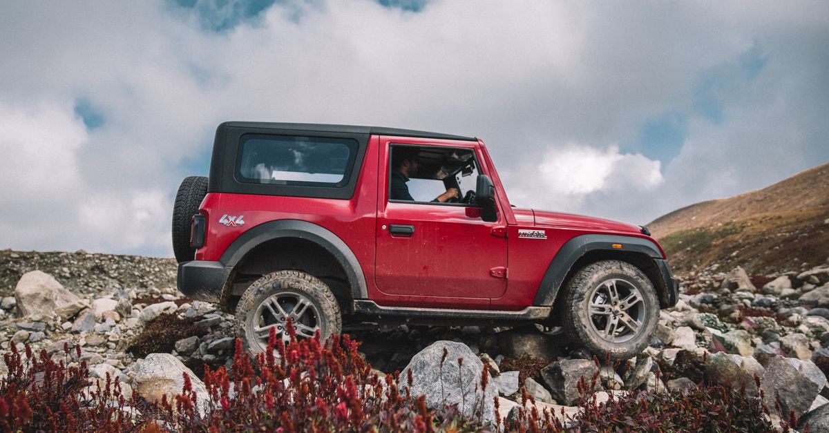Red 4x4 Car Driving Through Extreme Terrain · Free Stock Photo