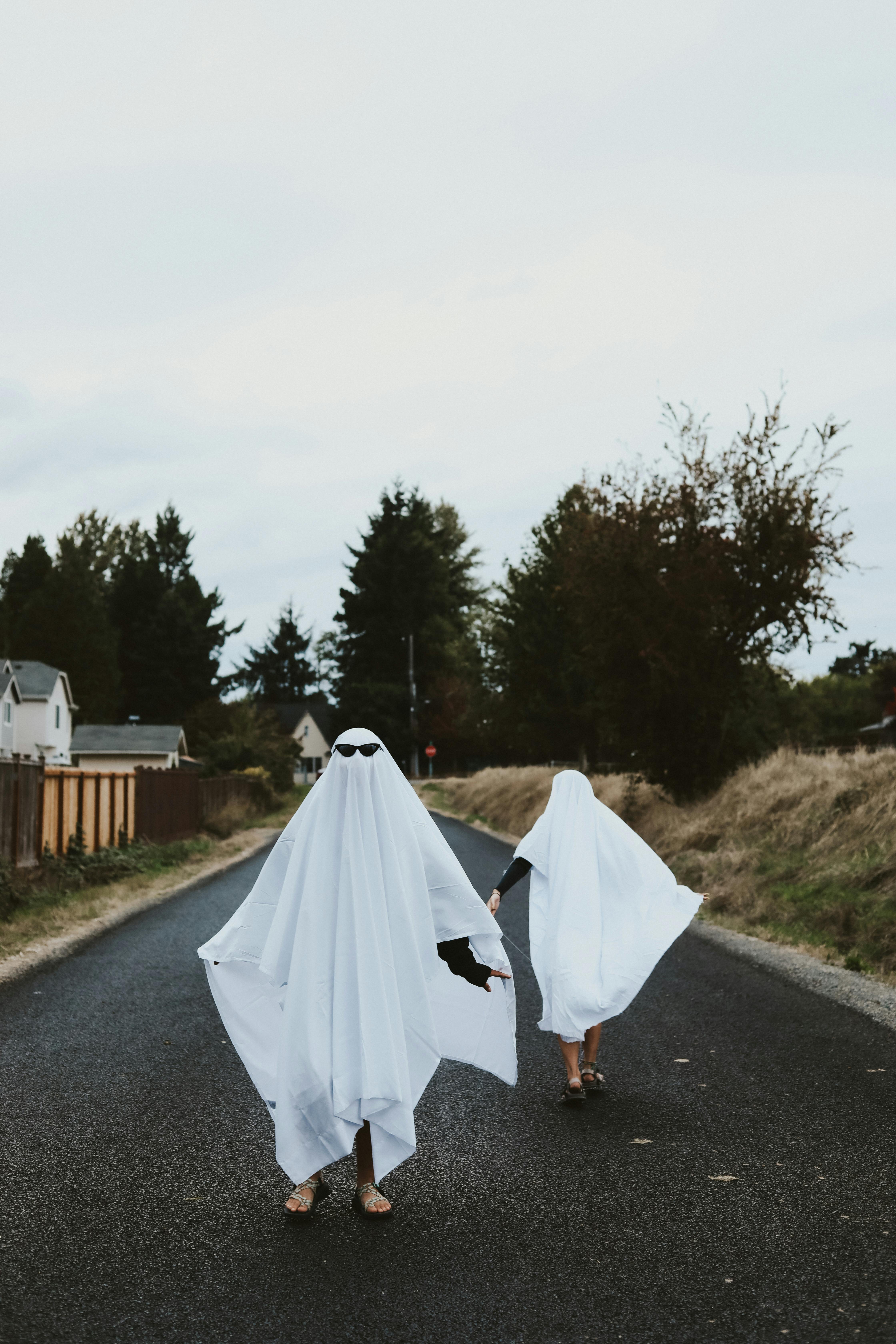 People In White Bedsheet Dressed as Ghosts · Free Stock Photo