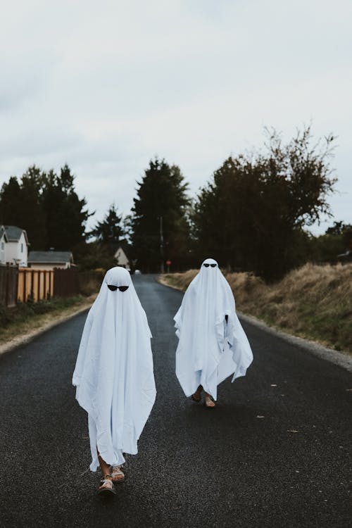 People Wearing Ghost Costumes Walking on Asphalt Road · Free Stock Photo