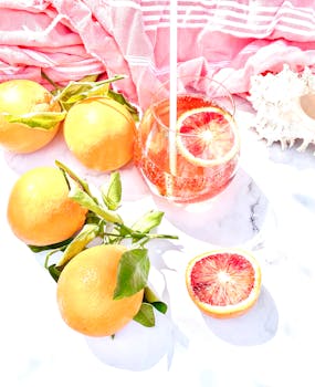 Vibrant citrus drink with fresh oranges on a bright day. Perfect summer vibe.