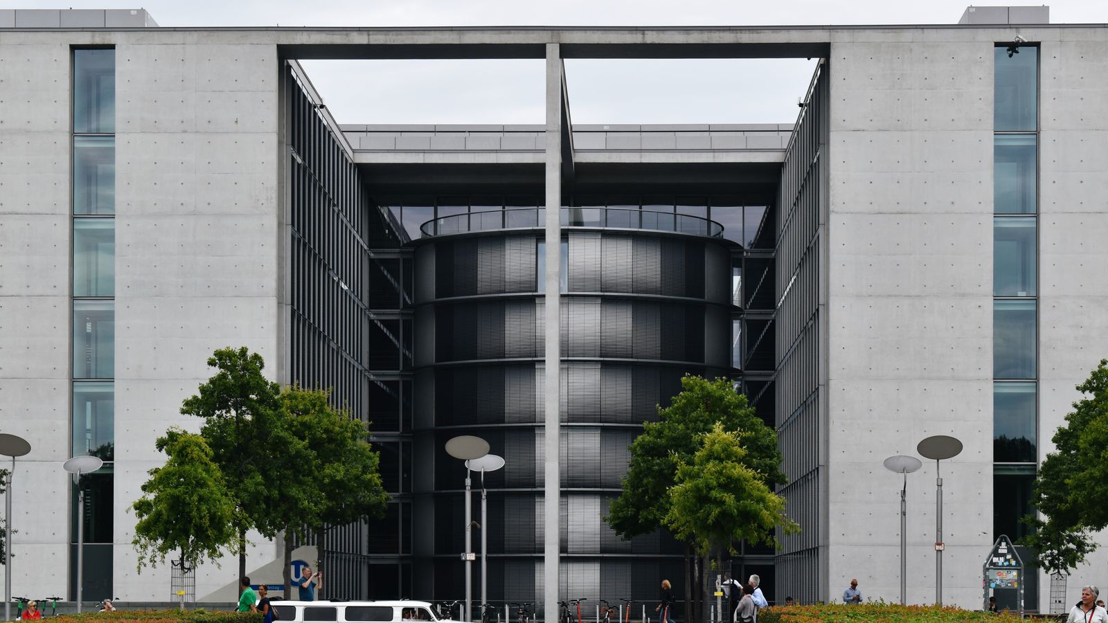 Contemporary architecture of a urban building facade with street and greenery in Berlin, Germany.