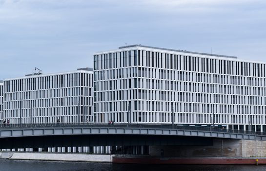 Contemporary office architecture by the river in Berlin, Germany featuring sleek design.