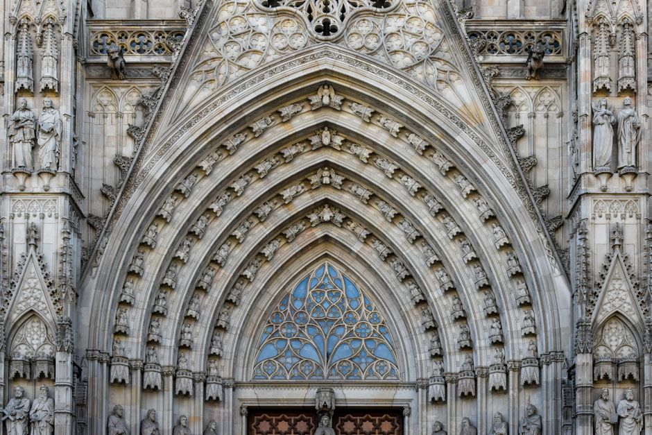 Detailed view of a Gothic cathedral's ornate facade, highlighting intricate arches and sculptures.