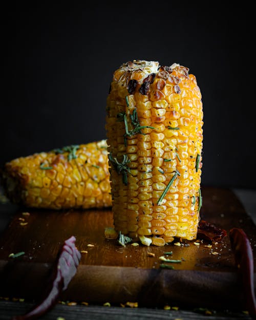 Close Up Shot of Corn on the Wooden Chopping Board