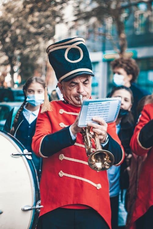 Man in Red Uniform Playing a Trumpet
