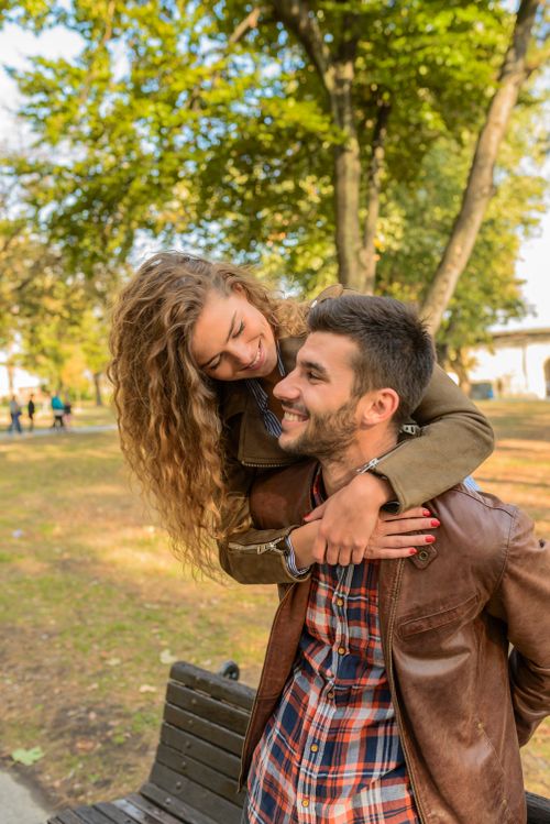 Couple smiling at each other over a shared meal