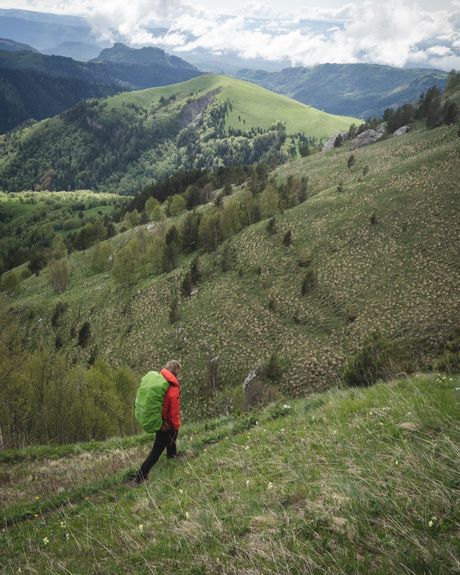 Hiker with a bright backpack on a mountain ridge — Greg Betanov on Pexels
