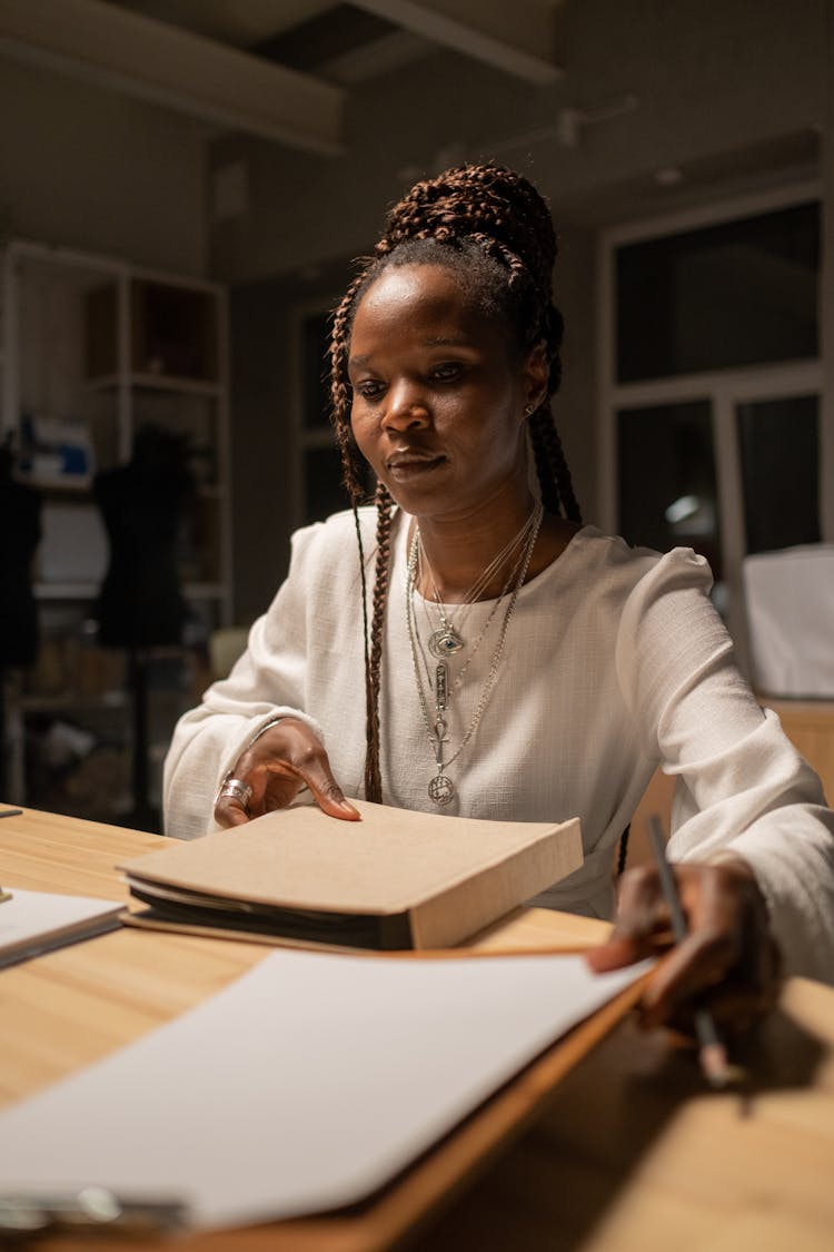 Woman In Dimly Lit Room Working