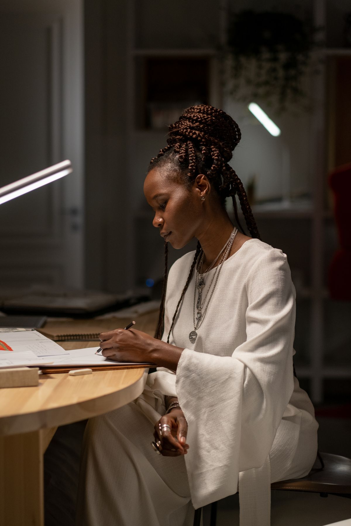 A professional designer sketching ideas in a focused creative workspace