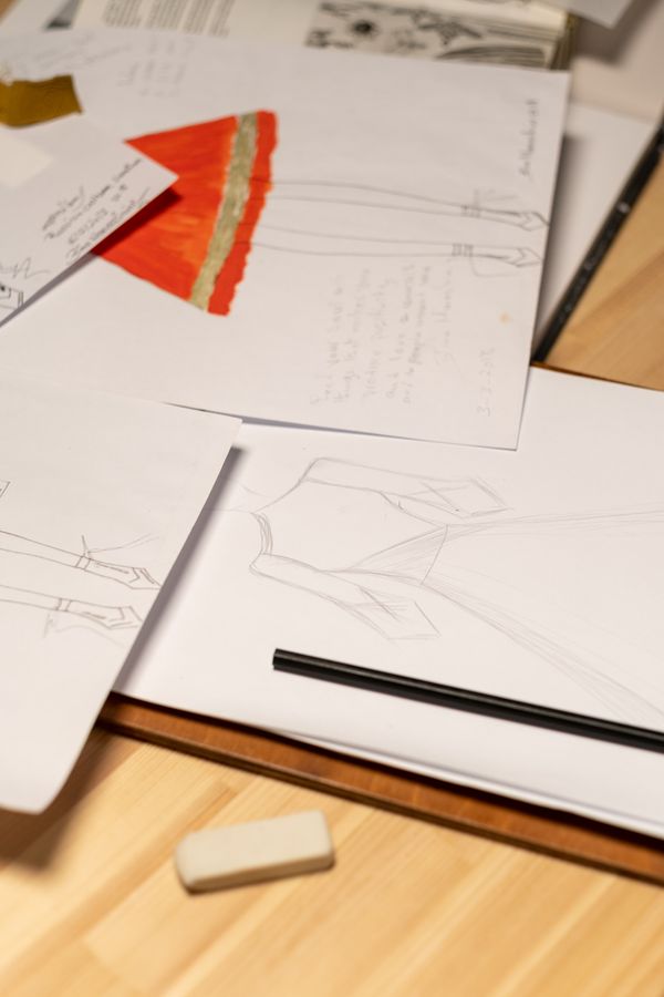 Sketches and colour studies spread across a desk — photo by Ron Lach on Pexels