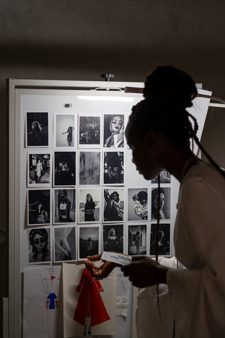 Woman Pinning Sketch To Wall