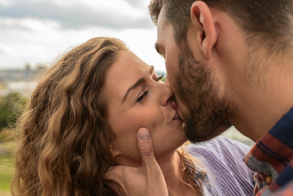 Free Man and Woman Kiss Each Other Stock Photo