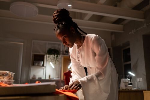 Free Focused young fashion designer sewing fabric in modern workspace. Stock Photo