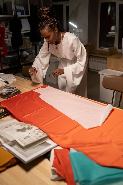 Free A female designer focuses on fabric design work in a creative studio environment. Stock Photo
