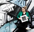 A Woman Leaning on Graffiti Wall Standing on One Leg
