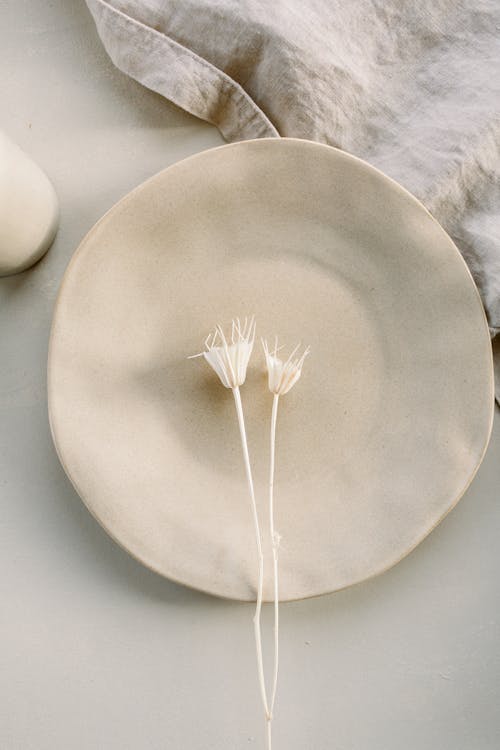 White Flowers over White Ceramic Plate