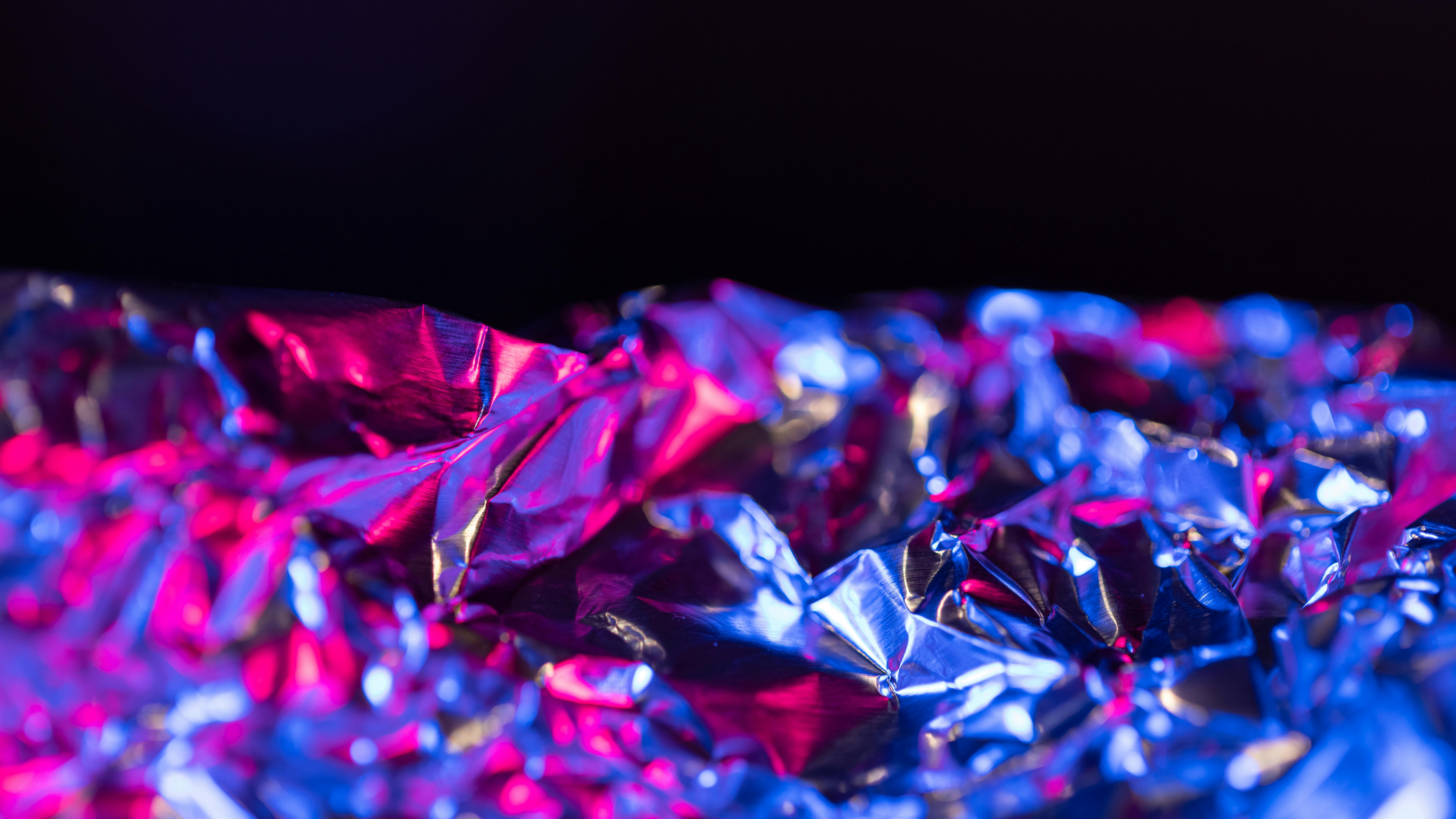 Premium Photo  Crumpled aluminum foil photographed with a red filter.  reflection and refraction of light in different directions