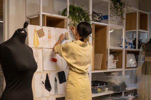 A Woman Pinning Sample Fabrics on Board