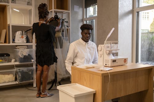 Man Sitting in front of a Sewing Machine