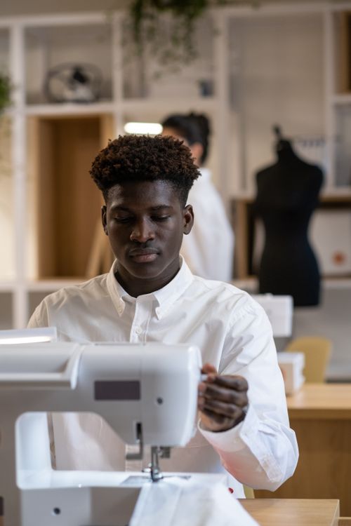 A Man in Front of a Sewing Machine · Free Stock Photo