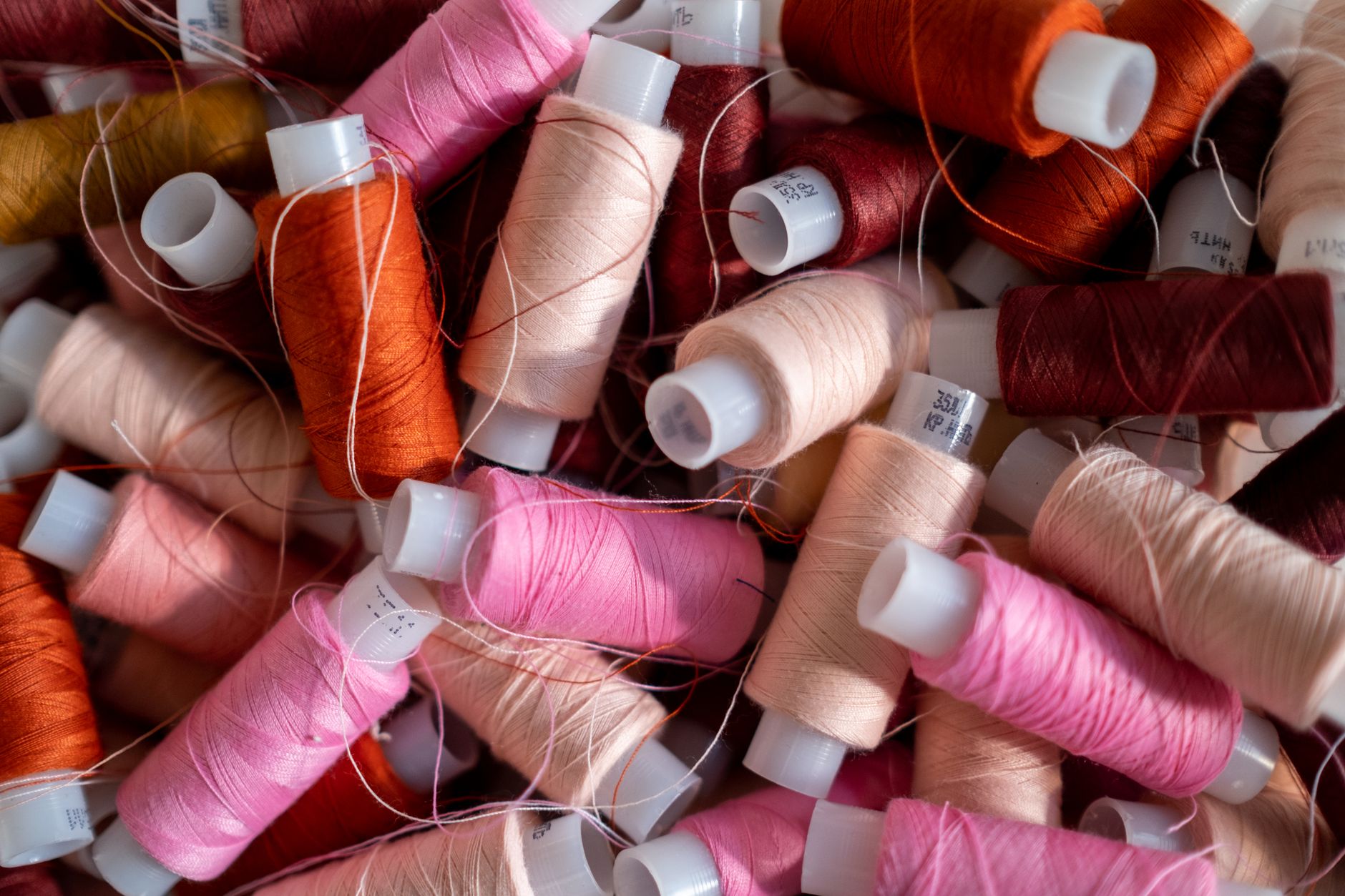 Vibrant threads in various colors and textures in a tailor's atelier. Perfect for fashion and textile themes.