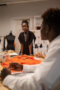 Fashion designers in a creative workspace, collaborating on a new project.