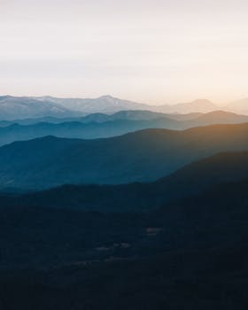 Beautiful layered mountains create a serene and calming landscape during sunset lighting.