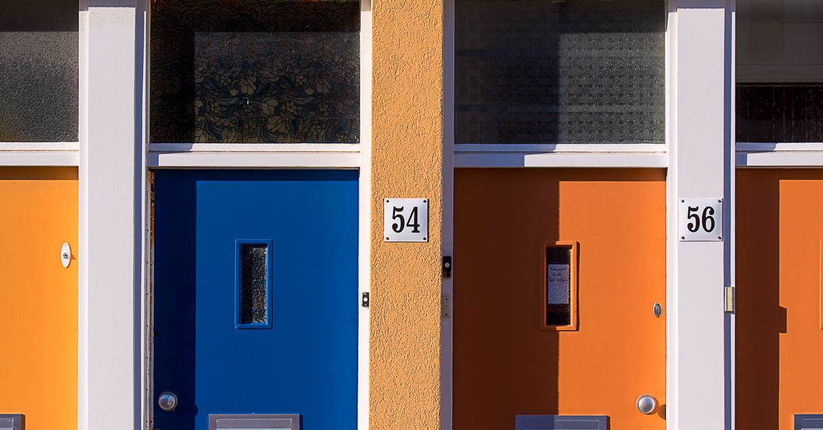 Brightly colored doors with numbers 54 and 56 on a modern building facade.