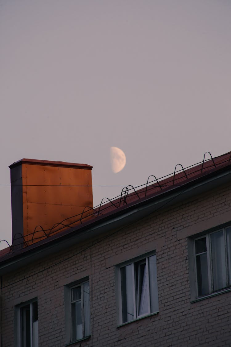 Moon In Three Quarter Phase Over Rooftop