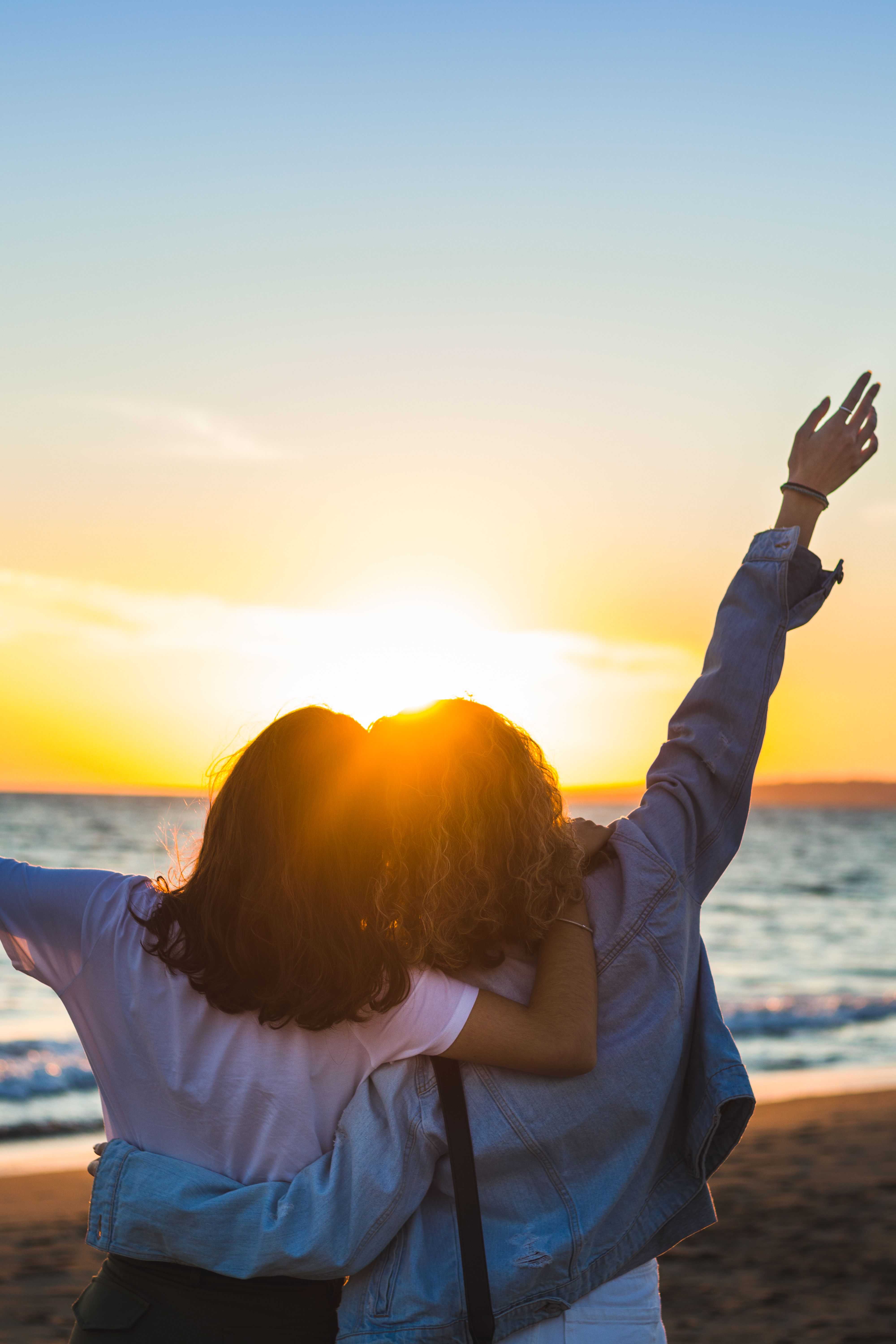 Friends Enjoying a Beach Sunset View · Free Stock Photo