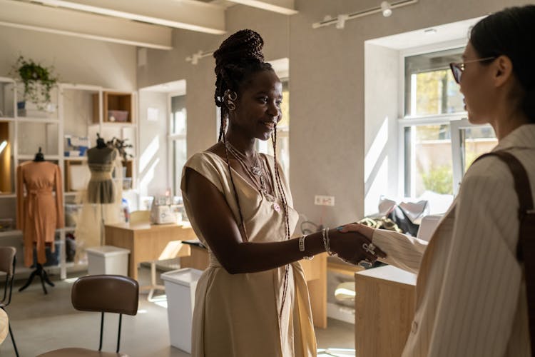 Two Women Shaking Hands In Fashion Studio