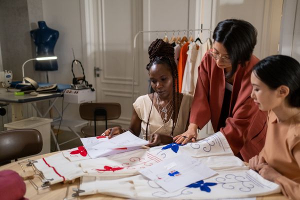 Members of the studio group collaborating around a work table — photo by Ron Lach on Pexels