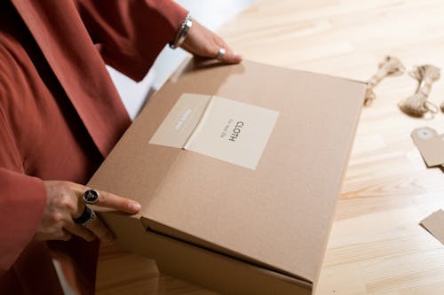 Person Holding a Brown Box