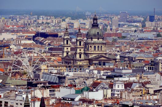 A breathtaking aerial view of Budapest featuring St. Stephen's Basilica and a Ferris wheel.