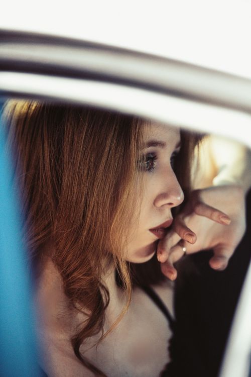 Free Pensive woman inside a car, deep in thought, side view. Stock Photo