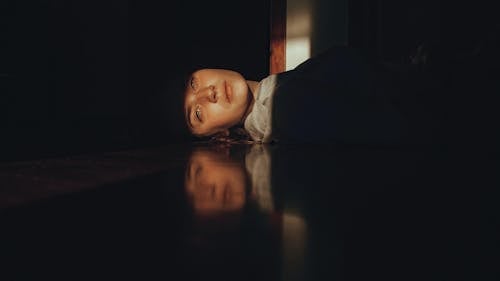 Girl Lying on the Floor and Looking at the Light