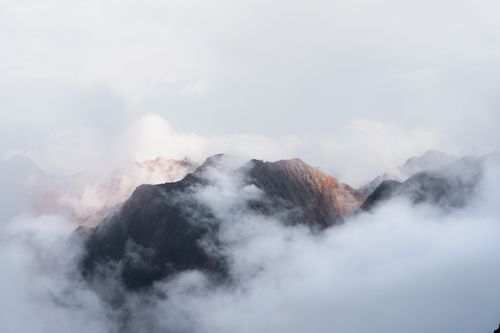 Free An ethereal view of mountain peaks shrouded in mist and clouds in Buryatia, Russia. Stock Photo