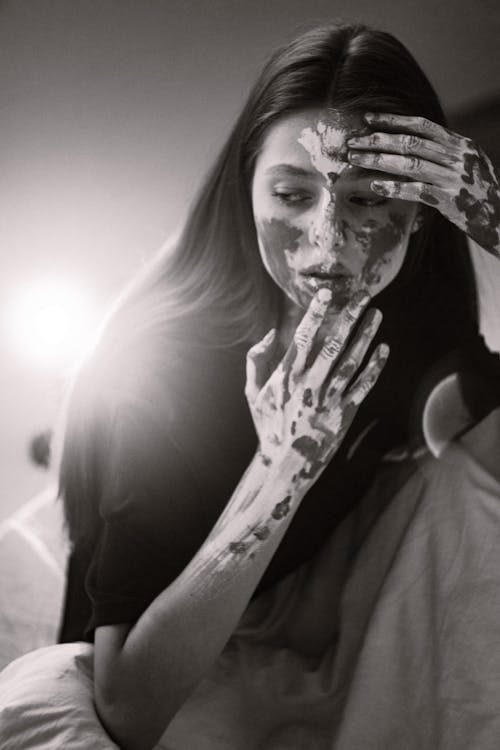 Pretty Woman with Paint on Face and Hands