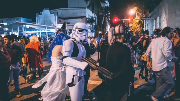 Crowded nighttime cosplay event with diverse costumes and vibrant atmosphere.